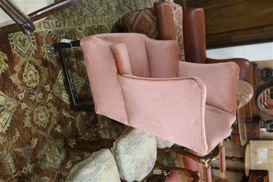 A George III mahogany framed pink dralon upholstered wing armchair